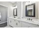 Bright bathroom featuring double sink vanity with modern fixtures and white marble countertops at 4307 Dristol Ave, Spring Hill, FL 34609