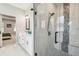 Ensuite bathroom with double sink vanity, white cabinets, and luxurious walk-in shower with glass door at 4307 Dristol Ave, Spring Hill, FL 34609