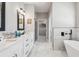 Bright bathroom with double vanity, glass enclosed shower, and a modern soaking tub at 4307 Dristol Ave, Spring Hill, FL 34609