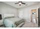 Carpeted bedroom featuring a bed, neutral paint, and a view of the ensuite bathroom at 4307 Dristol Ave, Spring Hill, FL 34609