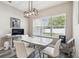 Bright dining area with modern table and chairs near a window, offering a cozy atmosphere at 4307 Dristol Ave, Spring Hill, FL 34609