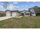 Charming single story home featuring a manicured lawn, two-car garage, and neutral exterior at 4307 Dristol Ave, Spring Hill, FL 34609