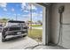 Garage view featuring an electric vehicle charging station and a sleek electric car parked outside at 4307 Dristol Ave, Spring Hill, FL 34609
