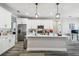 Well-lit kitchen featuring a central island with pendant lighting and stainless-steel appliances at 4307 Dristol Ave, Spring Hill, FL 34609