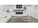 Open living room with a fireplace, modern floors, and bright lighting at 4307 Dristol Ave, Spring Hill, FL 34609