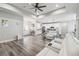 Open-concept living space with tray ceiling and modern fixtures seamlessly connects the living and dining areas at 4307 Dristol Ave, Spring Hill, FL 34609