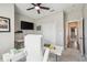 Home office with white desk, ceiling fan, television, and closet with neutral paint at 4307 Dristol Ave, Spring Hill, FL 34609