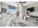 Well-lit home office with a modern white desk, comfortable seating, and neutral tones at 4307 Dristol Ave, Spring Hill, FL 34609