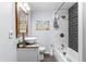 Modern bathroom with a stylish vessel sink, elegant mirror, and tiled shower-tub combination for a spa-like experience at 4803 N 9Th St, Tampa, FL 33603