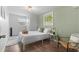 Bright bedroom featuring wood floors, natural light, and stylish, modern decor at 4803 N 9Th St, Tampa, FL 33603