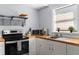 Well-lit kitchen featuring butcher block countertops and modern appliances at 4803 N 9Th St, Tampa, FL 33603