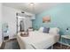 Serene main bedroom with a cozy bed, peaceful decor, and a glimpse into the convenient en-suite kitchen at 4803 N 9Th St, Tampa, FL 33603