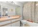 Bathroom featuring tiled floors, a large mirror above the sink and vanity, with a shower and tub at 5167 Sterling Manor Dr, Tampa, FL 33647