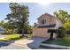 Charming two-story home with a two car garage and well maintained front yard with mature trees at 5167 Sterling Manor Dr, Tampa, FL 33647