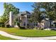 Charming two-story home showcasing a well-manicured lawn, mature trees, and an attached two-car garage at 5167 Sterling Manor Dr, Tampa, FL 33647