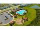 Aerial view of the community pool, playground, and parking area at 5758 Hollingworth Trl, Wesley Chapel, FL 33545