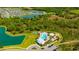 Aerial view of community amenities, including pool, playground, and lake at 5758 Hollingworth Trl, Wesley Chapel, FL 33545