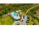 Aerial view of community amenities, pool, playground, and parking lot at 5758 Hollingworth Trl, Wesley Chapel, FL 33545
