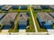 Aerial view of a home with gray siding, solar panels, and green grass at 5758 Hollingworth Trl, Wesley Chapel, FL 33545