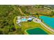 Aerial view of community pool, playground, parking and landscaped surroundings at 5758 Hollingworth Trl, Wesley Chapel, FL 33545