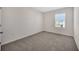 Clean and modern bedroom with carpet and a window with blinds at 5758 Hollingworth Trl, Wesley Chapel, FL 33545