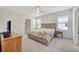 Cozy bedroom featuring carpet floors, neutral paint and natural light from the windows at 5758 Hollingworth Trl, Wesley Chapel, FL 33545