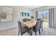 Bright dining area features sliding glass doors, seating for six and neutral decor at 5758 Hollingworth Trl, Wesley Chapel, FL 33545