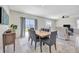 Elegant dining area featuring a modern table, grey chairs, and a view of the backyard at 5758 Hollingworth Trl, Wesley Chapel, FL 33545