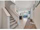 Inviting foyer features carpeted stairs and an entrance to a spacious living area at 5758 Hollingworth Trl, Wesley Chapel, FL 33545
