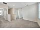 Bright hallway with neutral walls, carpet, and multiple doorways at 5758 Hollingworth Trl, Wesley Chapel, FL 33545