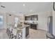 Open-concept kitchen with a granite island, seating, stainless appliances, and ample storage at 5758 Hollingworth Trl, Wesley Chapel, FL 33545