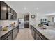 Well-equipped kitchen featuring granite countertops, stainless appliances, and dark cabinetry at 5758 Hollingworth Trl, Wesley Chapel, FL 33545