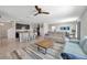Open floor plan of living room, kitchen with breakfast bar and tile flooring at 5758 Hollingworth Trl, Wesley Chapel, FL 33545