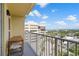 Balcony view overlooking city streets, nearby buildings, and distant water views with seating area for relaxing outdoors at 628 Cleveland St # 1208, Clearwater, FL 33755