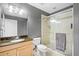 Bathroom featuring a glass-enclosed shower, granite countertop, and modern fixtures at 628 Cleveland St # 1208, Clearwater, FL 33755