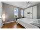 Bright bedroom with hardwood floors, two windows with shutters, and built-in white cabinetry at 628 Cleveland St # 1208, Clearwater, FL 33755