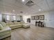 Spacious common area with a sectional sofa, pool table, dining table, and access to the outdoors at 628 Cleveland St # 1208, Clearwater, FL 33755