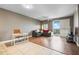 Open living room featuring a work space, hardwood floors, neutral tones, and a sliding door to a balcony with a view at 628 Cleveland St # 1208, Clearwater, FL 33755