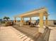 Relaxing rooftop terrace features a pergola with dining area and outdoor kitchen, perfect for sunset dinners at 628 Cleveland St # 1208, Clearwater, FL 33755