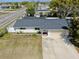 Single-story home with paved driveway and a nicely-sized yard at 7205 Mayfield Dr, Port Richey, FL 34668