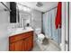 Bathroom showcasing vanity, toilet, and tiled shower with curtain at 7205 Mayfield Dr, Port Richey, FL 34668