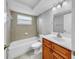 Bright bathroom featuring a tub/shower combo and a vanity with ample storage space at 7205 Mayfield Dr, Port Richey, FL 34668