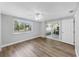 Bedroom with wood floor, ceiling fan, and sliding glass doors to the patio at 7205 Mayfield Dr, Port Richey, FL 34668