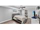Bedroom features a gray bed frame, updated flooring, and neutral paint at 7205 Mayfield Dr, Port Richey, FL 34668