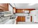 A kitchen with beautiful granite countertops and wooden cabinets at 7205 Mayfield Dr, Port Richey, FL 34668
