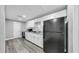 Kitchen features white cabinets, granite counters, subway tile backsplash, and black appliances at 7205 Mayfield Dr, Port Richey, FL 34668