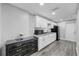Clean kitchen featuring white cabinets, gray countertops and black appliances at 7205 Mayfield Dr, Port Richey, FL 34668
