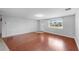 Bright living room featuring hardwood floors, fresh paint, and ample natural light at 7205 Mayfield Dr, Port Richey, FL 34668