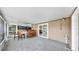 Enclosed patio with tile flooring, a bar, and sliding glass doors to the interior at 7205 Mayfield Dr, Port Richey, FL 34668