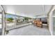 Enclosed patio with tile flooring, a bar, and views of the backyard at 7205 Mayfield Dr, Port Richey, FL 34668